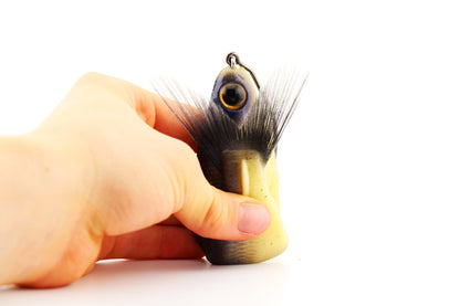 Soft Dad Dry Bones silicone glide bait flexed by hand showing its soft durable body, jointed construction and fiber tail.