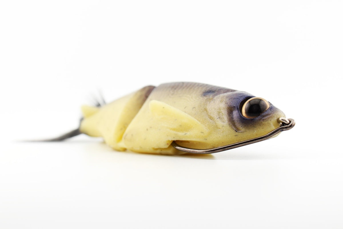 Soft Dad silicone glide bait in Dry Bones color shown from a front quarter angle with realistic baitfish profile and weedless hook.