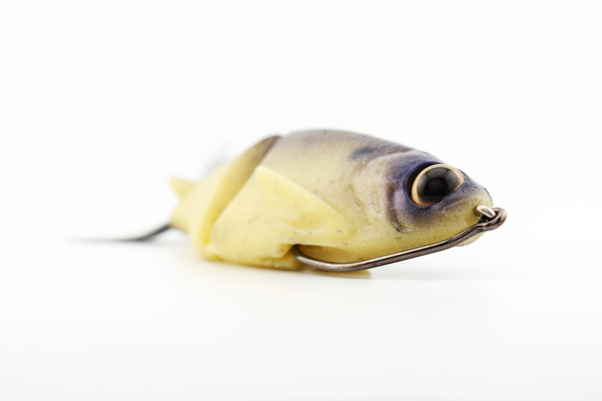 Close-up of the Soft Dad Dry Bones silicone glide bait showing the detailed head, molded eye and weedless hook.