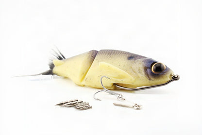 Soft Dad silicone glide bait in Dry Bones color shown with weedless hook, bottom treble rig and removable tungsten weights.